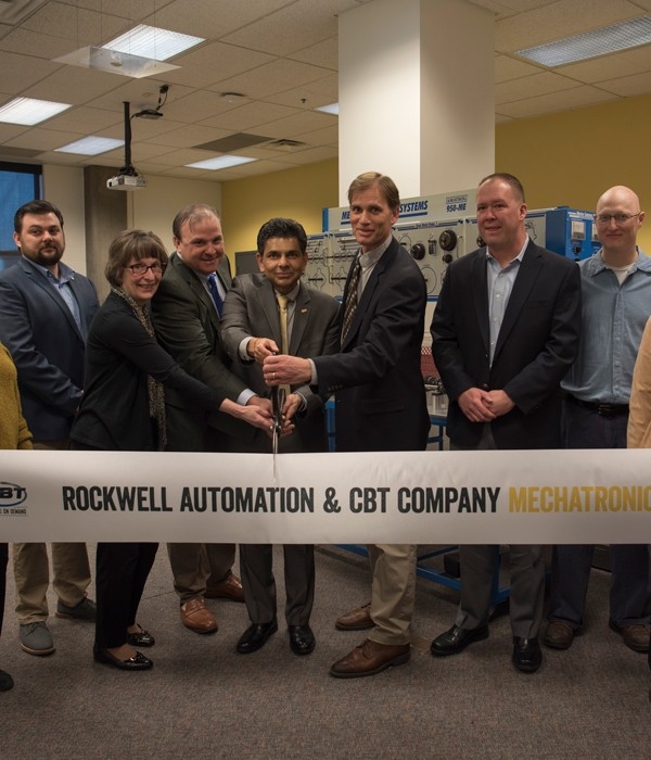 People participating in a ribbon-cutting ceremony.